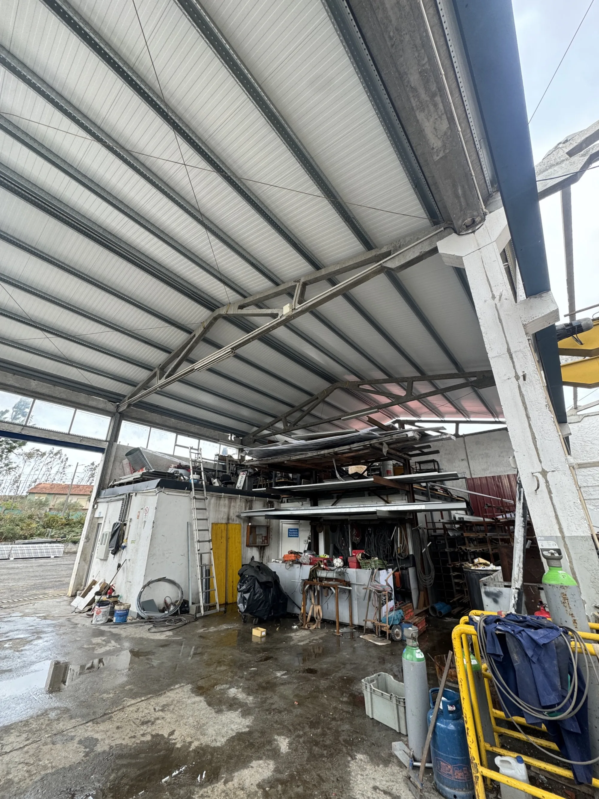 Interior da oficina, com bancada de trabalho e material em stock